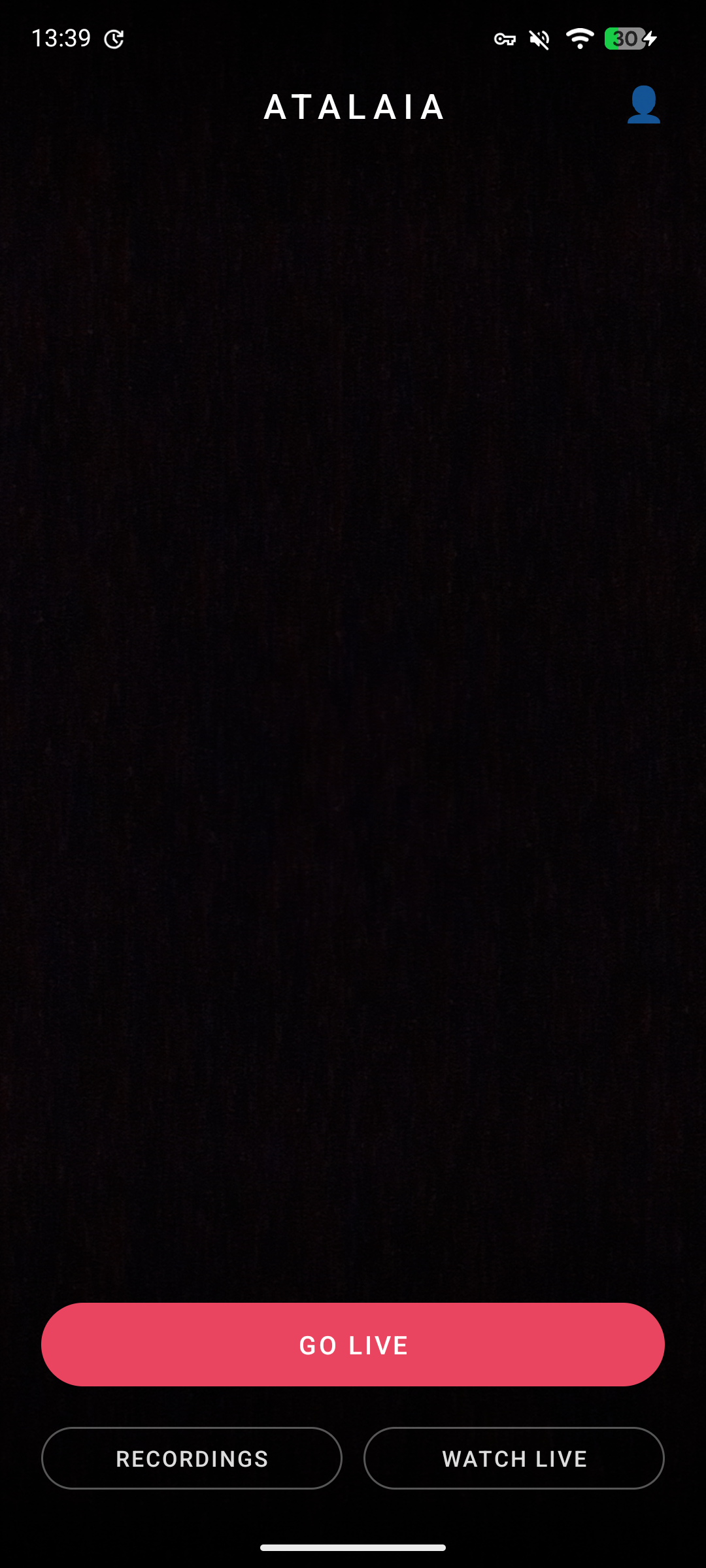 Atalaia home screen on a Pixel 7a: ATALAIA wordmark at top, large red GO LIVE button in the centre, RECORDINGS and WATCH LIVE buttons at the bottom. Pure AMOLED black background.